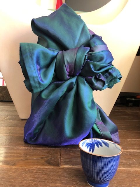 Furoshiki style wrapping using a repurposed shower curtain.